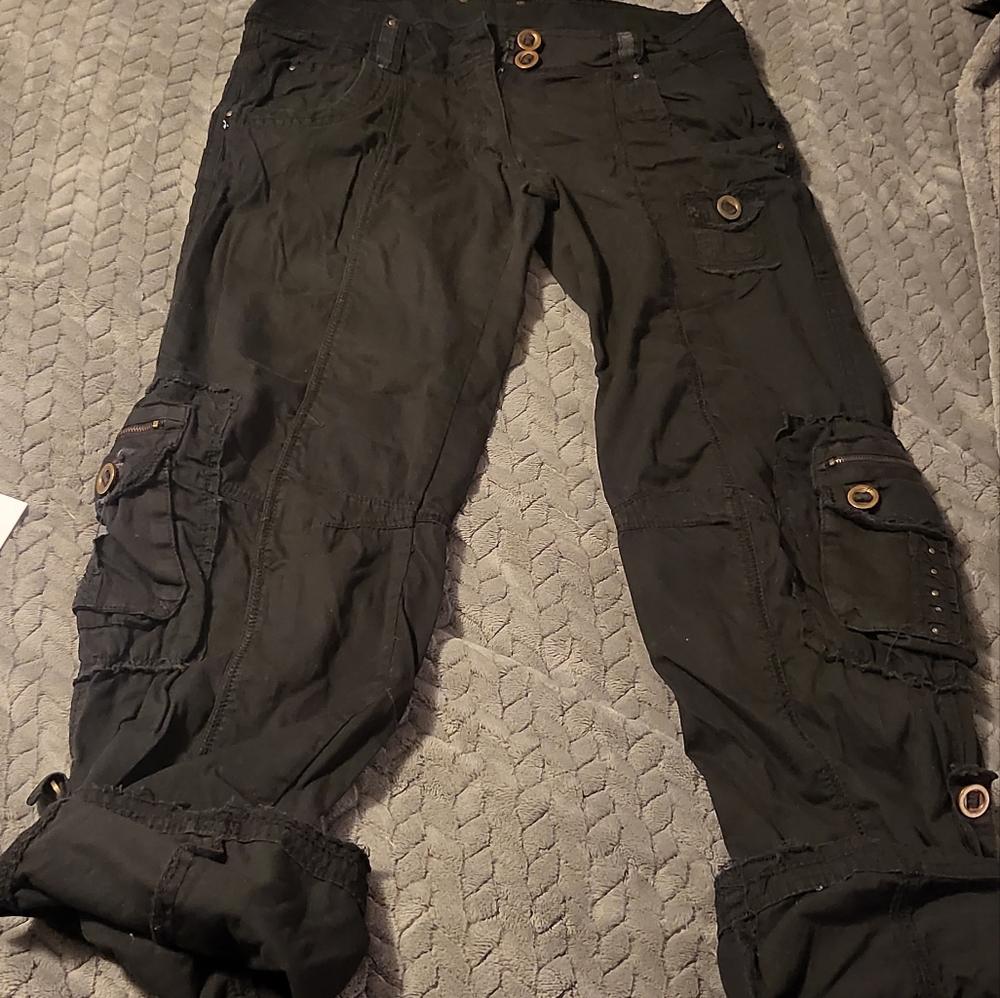 Black army pants go from crop to pants with gold zipper and snaps